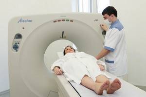 How is a CT scan of the brain performed?