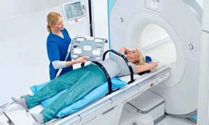 How is an abdominal CT scan performed?