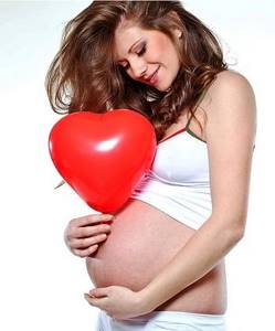 Happy young woman expecting a baby
